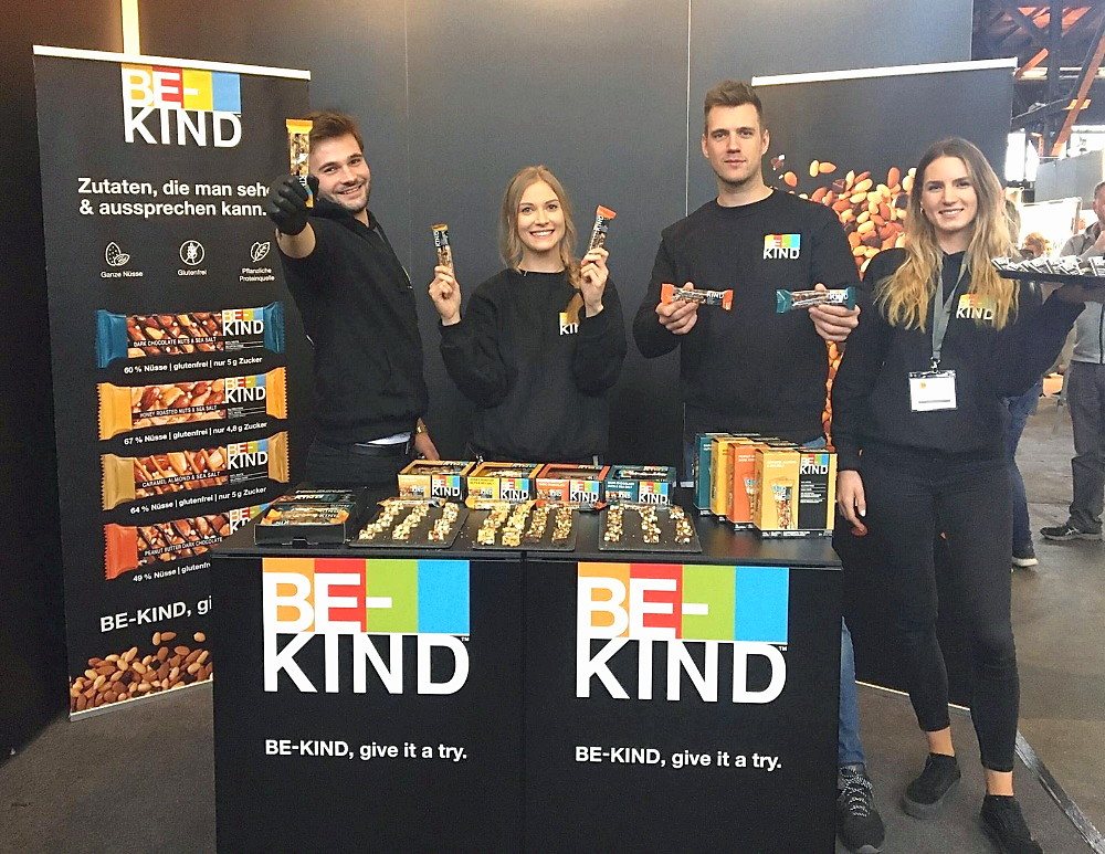be-kind-promotion-team-am-sampling-stand-mit-produktdisplay-hero BE-KIND Promotion-Team am Sampling-Stand mit Produktdisplay